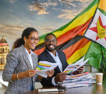 Firefly journalists writing stories and people buying newspapers in Zimbabwe flag 28876